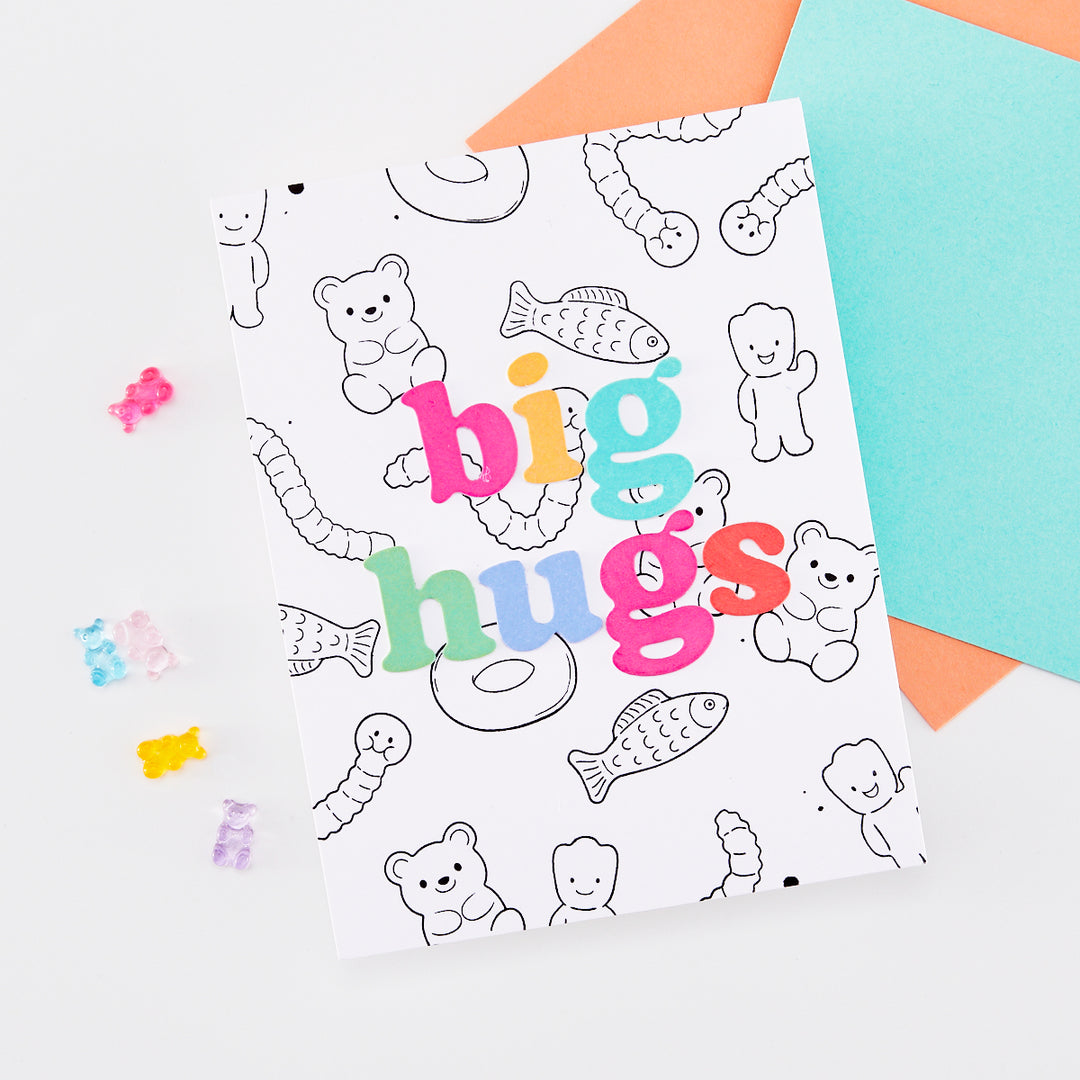 Card with 'big hugs' phrase and gummy bear and gummy worm line art in the background.