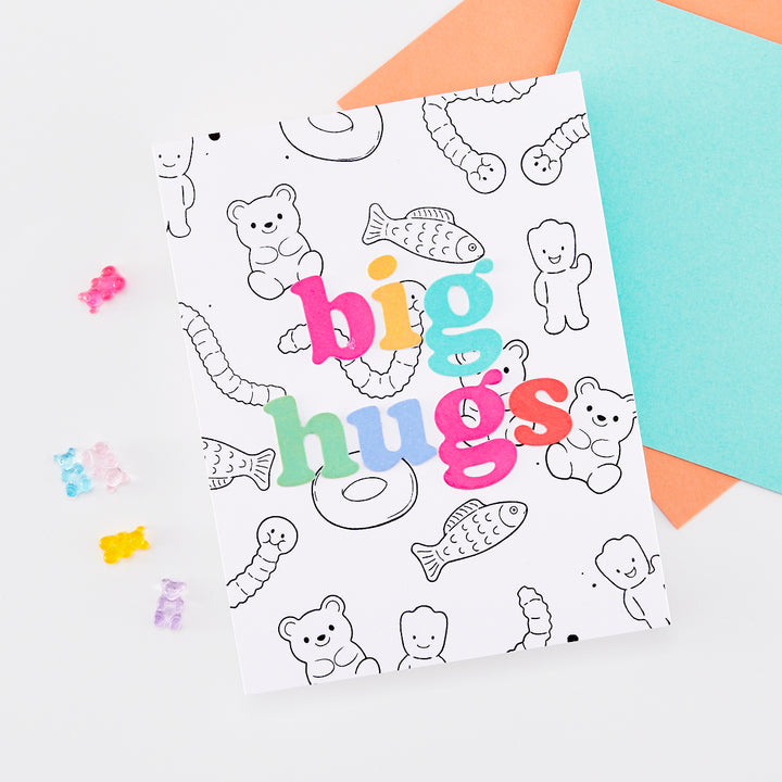 Card with 'big hugs' phrase and gummy bear and gummy worm line art in the background.